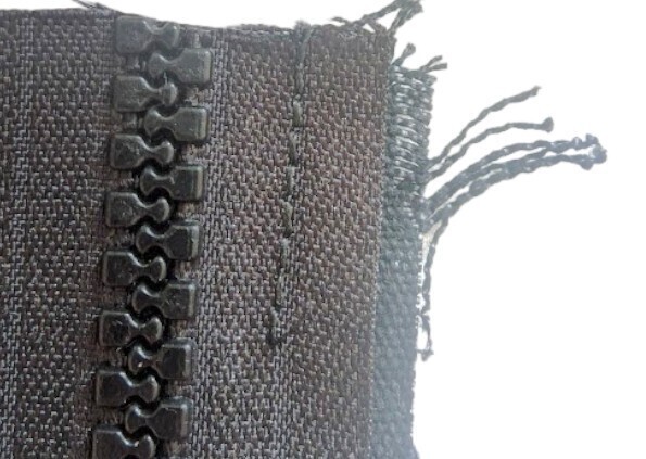 Fabric fraying around a sewn in zip
